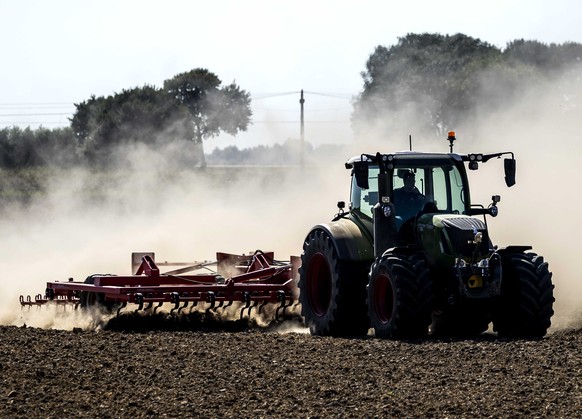 epa10113946 A farmer plows his parched fields in Landelijk, the Netherlands, 10 August 2022. The ongoing drought and heatwave across much of Europe is causing low water levels and water shortages. EPA ...