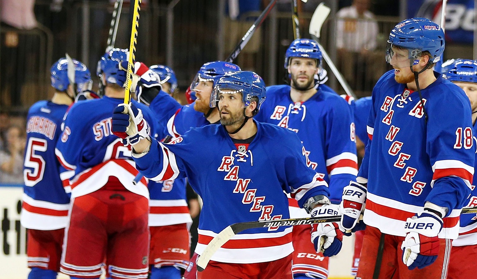NEW YORK, NY - MAY 11: Martin St. Louis #26 of the New York Rangers celebrates their 3 to 1 win over the Pittsburgh Penguins with teammates in Game Six of the Second Round of the 2014 NHL Stanley Cup  ...