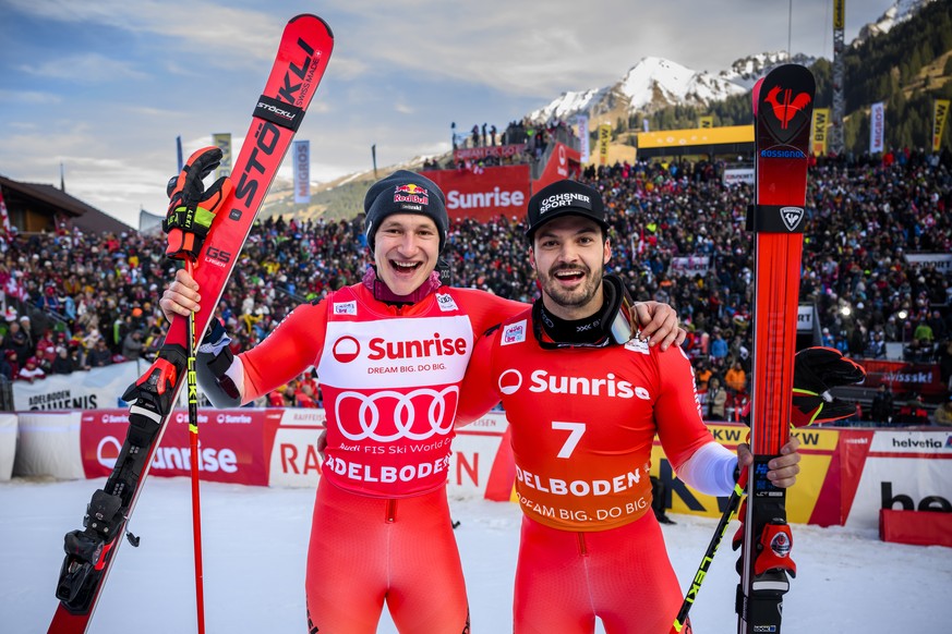 epa10394282 Winner Marco Odermatt (L) of Switzerland and third placed Loic Meillard of Switzerland celebrate during the Men&#039;s Giant Slalom race at the FIS Alpine Skiing World Cup in Adelboden, Sw ...