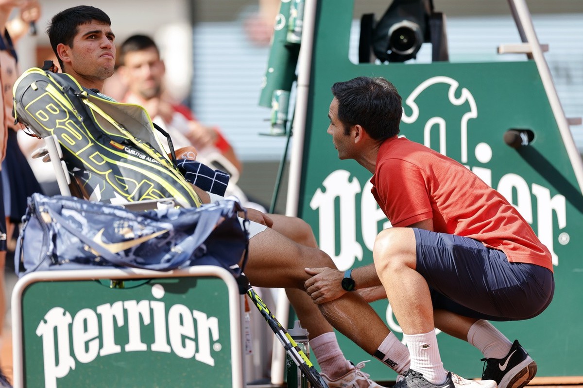 Spain's Carlos Alcaraz receives medical assistance during his semifinal match of the French Open tennis tournament against Serbia's Novak Djokovic at the Roland Garros stadium in Paris, Frid ...