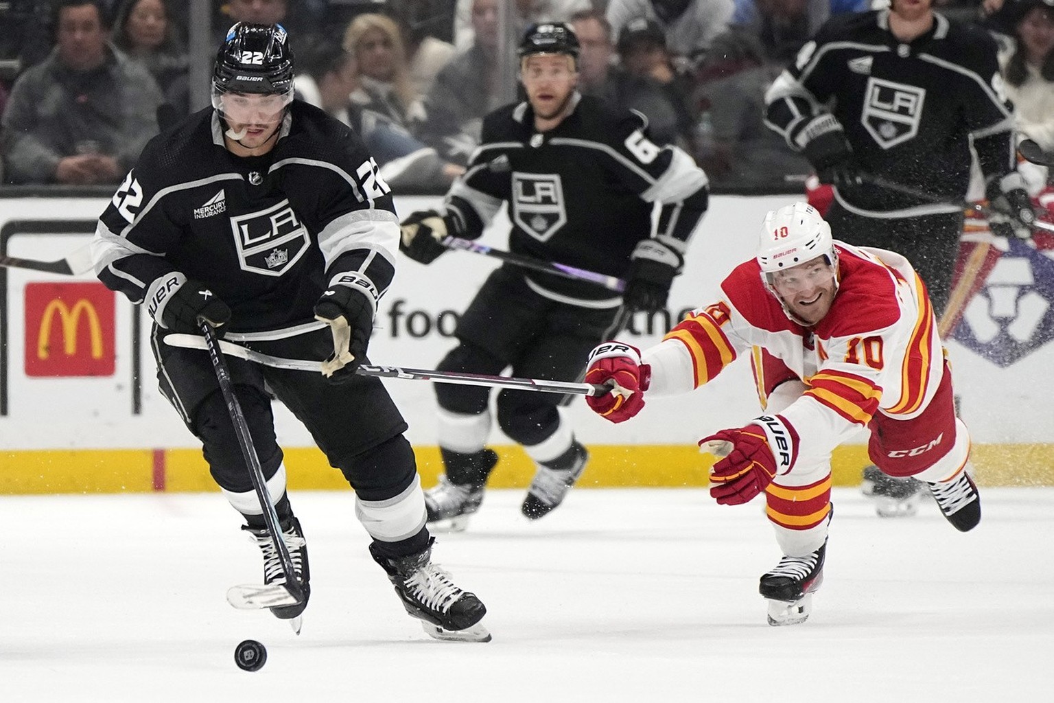 Los Angeles Kings left wing Kevin Fiala, left, takes the puck as Calgary Flames center Jonathan Huberdeau reaches in during the second period of an NHL hockey game Thursday, April 11, 2024, in Los Ang ...
