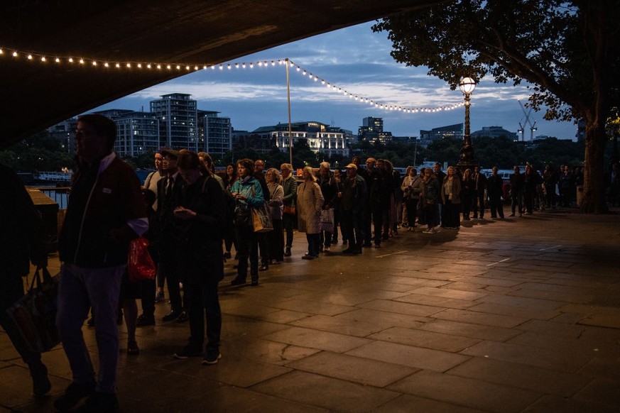 LONDON, ENGLAND - SEPTEMBER 15: Well-wishers stand in the queue along Southback for the Lying-in State of Queen Elizabeth II on September 15, 2022 in London, England. Queen Elizabeth II is lying in st ...