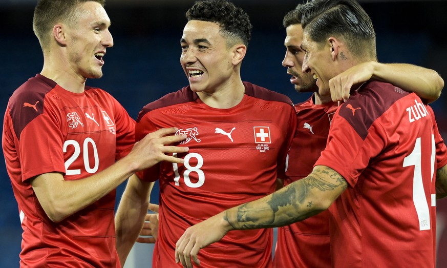 epa09441627 Ruben Vargas (2L) of Switzerland celebrates with teammates after scoring the 2-1 lead during an international soccer test match between Switzerland and Greece at the St. Jakob-Park stadium ...