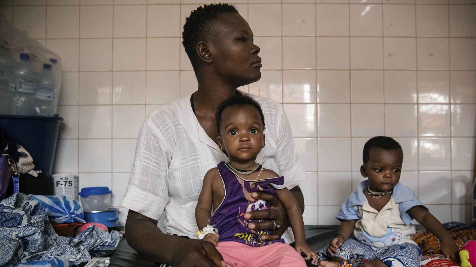 FILE- Malnourished children wait for treatment in the pediatrics department of Boulmiougou hospital in Ouagadougou, Burkina Faso, on April 15, 2022. The United Nations food agency says millions of hun ...