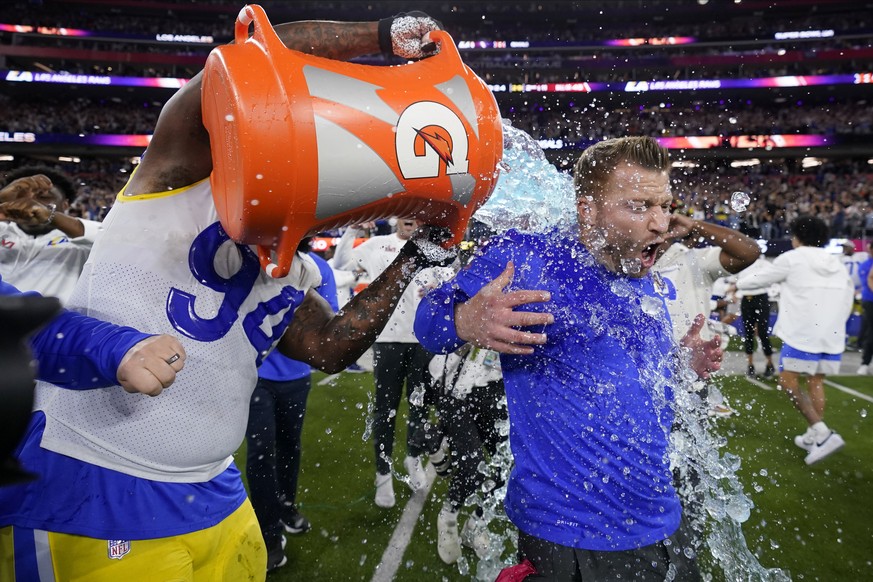 Los Angeles Rams defensive end A&#039;Shawn Robinson, left, pours Gatorade over Los Angeles Rams head coach Sean McVay after the Rams defeated the Cincinnati Bengals NFL Super Bowl 56 football game Su ...