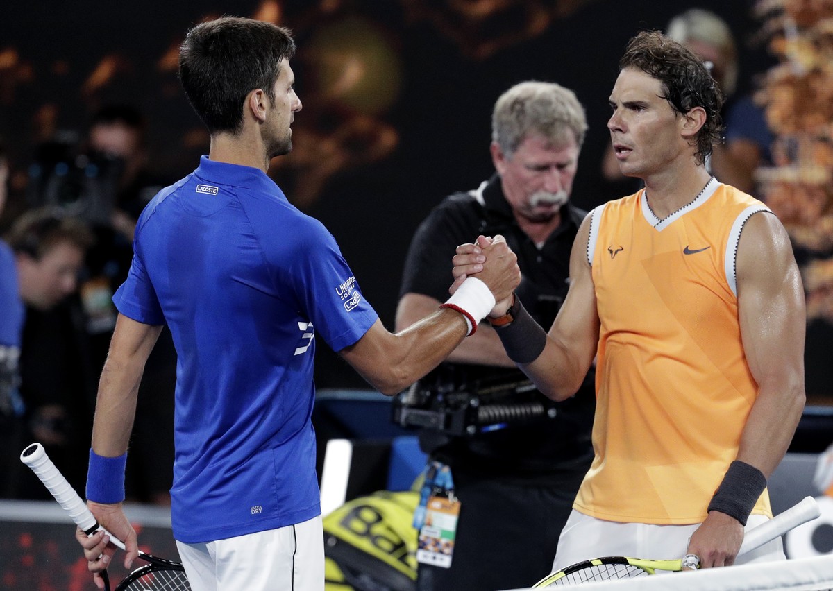 Spain's Rafael Nadal, right, congratulates Serbia's Novak Djokovic after Djokovic won the men's singles final at the Australian Open tennis championships in Melbourne, Australia, Sunday ...