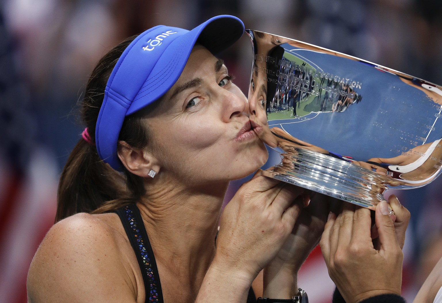 FILE - In this Sunday, Sept. 10, 2017 file photo, Martina Hingis, of Switzerland, kisses the women&#039;s doubles championship trophy with parnter Chan Yung-Jan, of Taiwan, after beating Katerina Sini ...