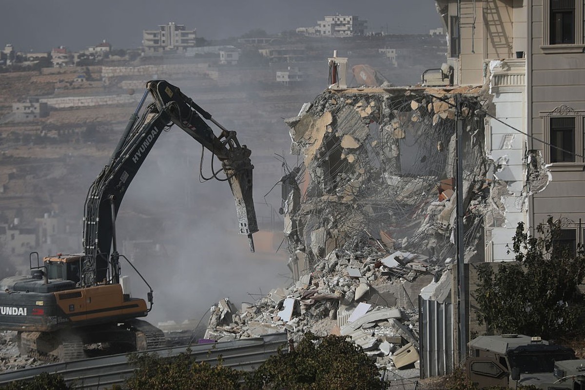 HEBRON, WEST BANK, PALESTINE - OCTOBER 23: Israeli military heavy machinery demolishes a building during a raid in the West Bank city of Hebron, Palestine, on October 23, 2026. The Israeli military an ...