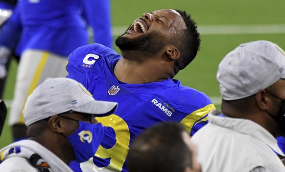 Los Angeles Rams' Aaron Donald celebrates after Morgan Fox sacked New England Patriots quarterback Jarrett Stidham during the fourth quarter of an NFL football game Thursday, Dec. 10, 2020, in In ...