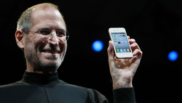 FILE - In this June 7, 2010, file photo, Apple CEO Steve Jobs smiles with a new iPhone at the Apple Worldwide Developers Conference in San Francisco. In the white-hot competition for tech talent, some ...