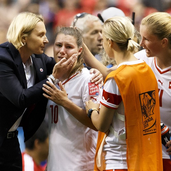 Switzerland&#039;s Ramona Bachmann, 2nd left, crying is consoled by Switzerland&#039;s head coach Martina Voss-Tecklenburg, from Germany, and Switzerland&#039;s players Vanessa Buerki, 2nd right, Rach ...