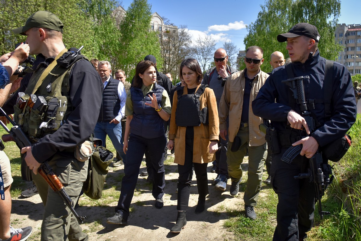 epa09937848 Prosecutor General of Ukraine Iryna Venediktova (L) speaks with German Foreign Minister Annalena Baerbock (R) during her visit to the church and adjacent mass grave sites in Bucha, Ukraine ...