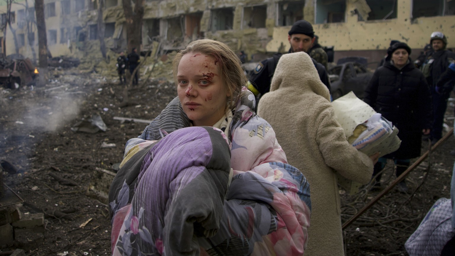 FILE - Marianna Vishegirskaya stands outside a maternity hospital that was damaged by shelling in Mariupol, Ukraine, Wednesday, March 9, 2022. (AP Photo/Mstyslav Chernov, File)