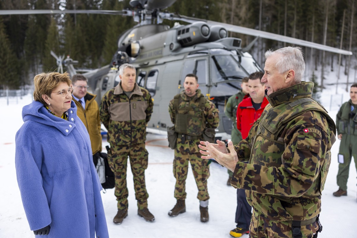 Switzerland's Defense Minister Federal Councillor Viola Amherd, left, listens to the Army divisional commander Maurizio Dattrino, right, during visits the troops of the Army's operations cen ...
