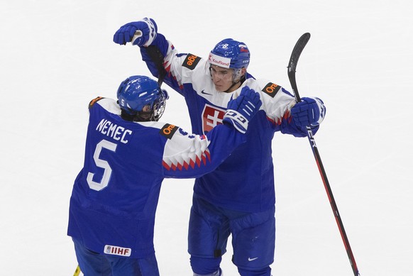 Slovakia defenceman Simon Nemec (5) celebrates his goal with teammate Martin Chromiak against Canada during the third period of an IIHF World Junior Hockey Championship game in Edmonton, Alberta, on S ...