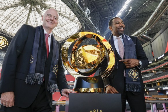 Atlanta Mayor Andre Dickens, right, and FIFA President Gianni Infantino, left, pose with the FIFA Club World Cup trophy after a news conference at Mercedes-Benz Stadium, Monday, April 14, 2025, to dis ...