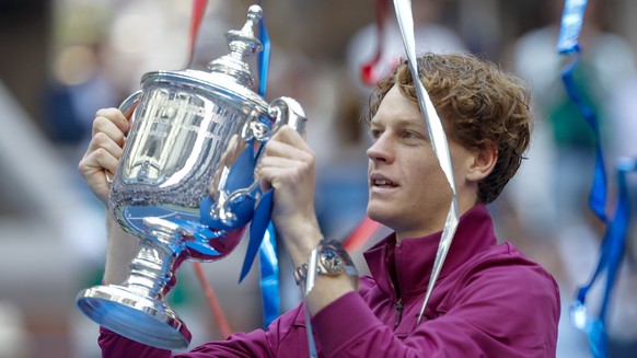 epa11593833 Jannik Sinner of Italy holds the US Open Championship Trophy after his victory against Taylor Fritz of the United States during their men&#039;s final match of the US Open Tennis Champions ...