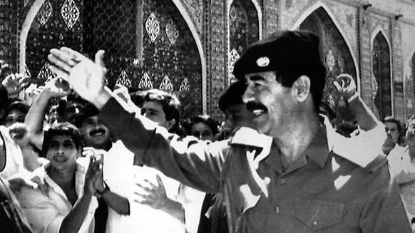 FILE - In this Aug. 9, 1988 file photo, Iraqi President Saddam Hussein waves to cheering crowds during a visit to the holy muslim shrines in Samara. The Iraqi President visited the site for prayers an ...