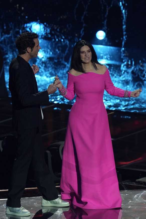 Hosts of the Eurovision Song Contest Laura Pausini, right, and Alessandro Catalan talk on stage during rehearsals at the Eurovision Song Contest in Turin, Italy, Monday, May 9, 2022. (AP Photo/Luca Br ...