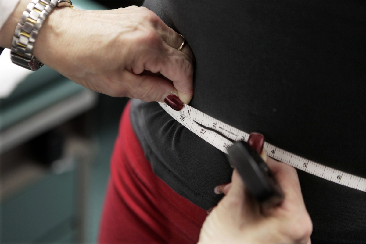 FILE - In this Jan. 20, 2010 file photo, a subject's waist is measured during an obesity prevention study in Chicago. Obesity rates in the U.S. have been rising steadily for well over a decade an ...