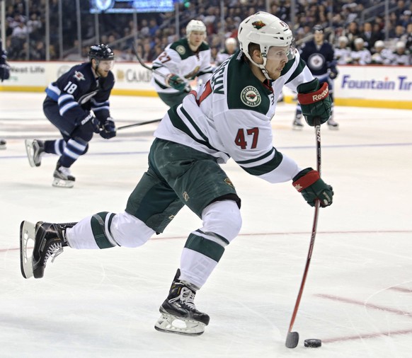 Sep 29, 2016; Winnipeg, Manitoba, CAN; Minnesota Wild forward Christoph Bertschy (47) shoots the puck against Winnipeg Jets goalie Connor Hellebuyck (not pictured) during the first period during a pre ...