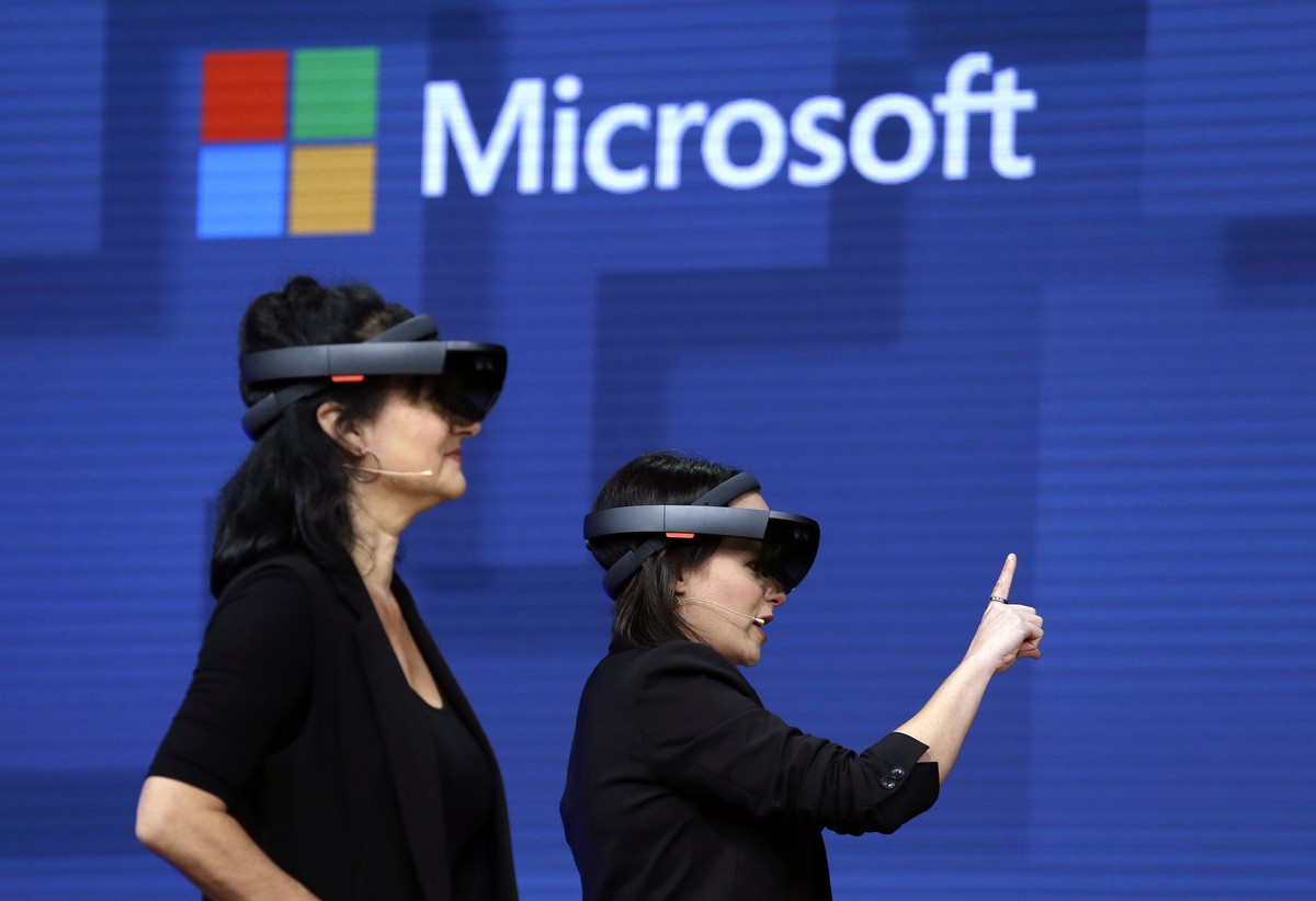 FILE- In this May 11, 2017, file photo, members of a design team at Cirque du Soleil demonstrate use of Microsoft's HoloLens device in helping to virtually design a set at the Microsoft Build 201 ...