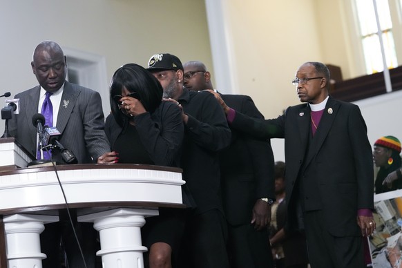 RowVaugn Wells, second from left, mother of Tyre Nichols, who died after being beaten by Memphis police officers, cries as she is comforted by Tyre's stepfather Rodney Wells, behind her, at a news con ...