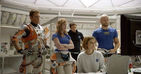 In this photo provided by Twentieth Century Fox, Matt Damon, from left, as Astronaut Mark Watney, Jessica Chastain as Melissa Lewis, Sebastian Stan as Chris Beck, Kate Mara as Beth Johanssen, and Akse ...