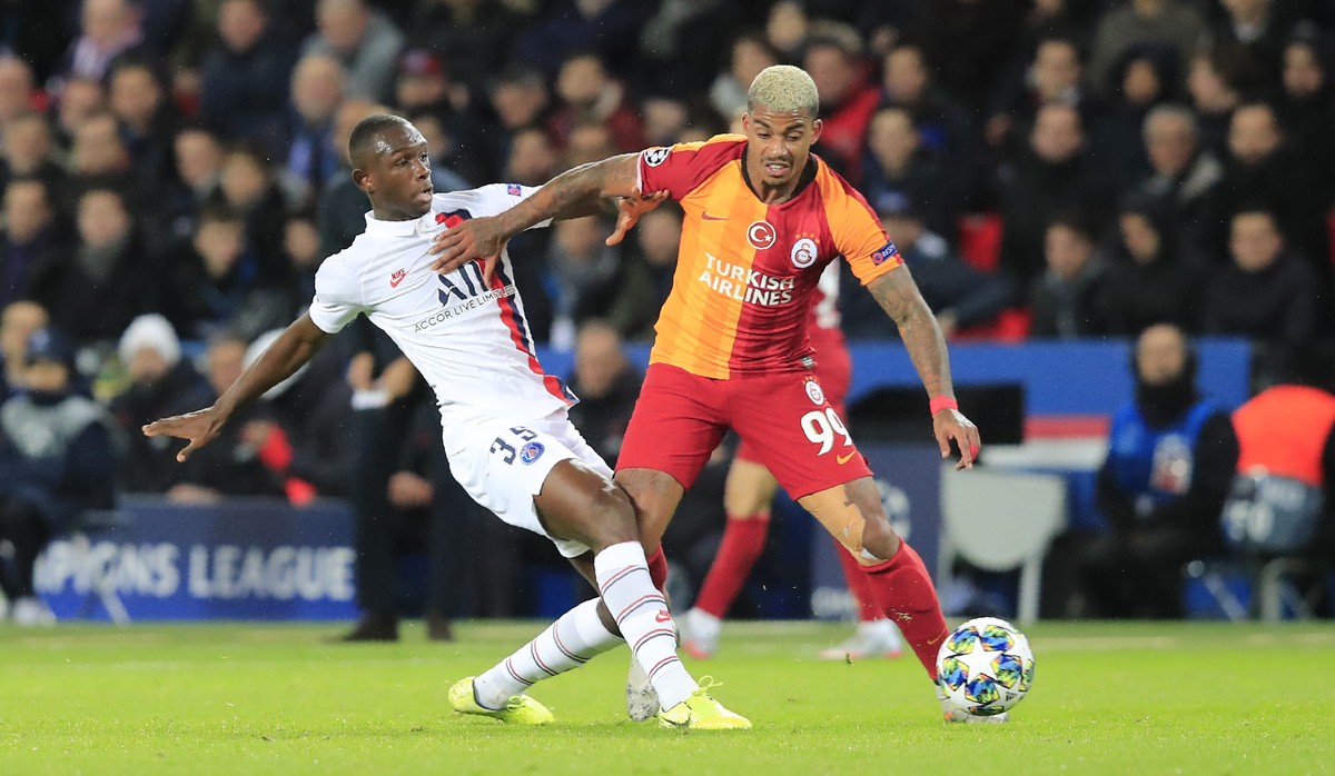 PSG's Tanguy Kouassi, left, challenges for the ball with Galatasaray's Mario Lemina during the Champions League, group A soccer match between PSG and Galatasaray, at the Parc des Princes sta ...
