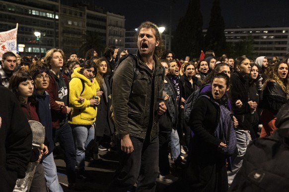 Demonstrators shout anti-government slogans during a protest in front of the parliament, in Athens, Friday, March 3, 2023. Thousands took to the streets to protest the deaths of dozens of people late  ...