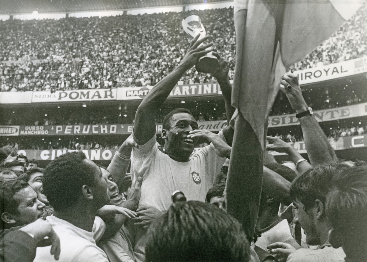 Brazil's Pele (Edson Arantes do Nascimento) has a big smile as he holds the Jules Rimet Trophy, following Brazil's 4-1 victory over Italy in the World Cup finals at the Azteca Stadium in Mex ...