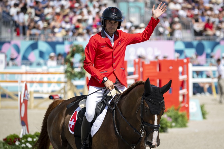 Felix Vogg of Switzerland reacts after crossing the finish line on his horse named Dao de L'Occean and competes during the equestrian eventing individual jumping final, at the 2024 Paris Summer O ...