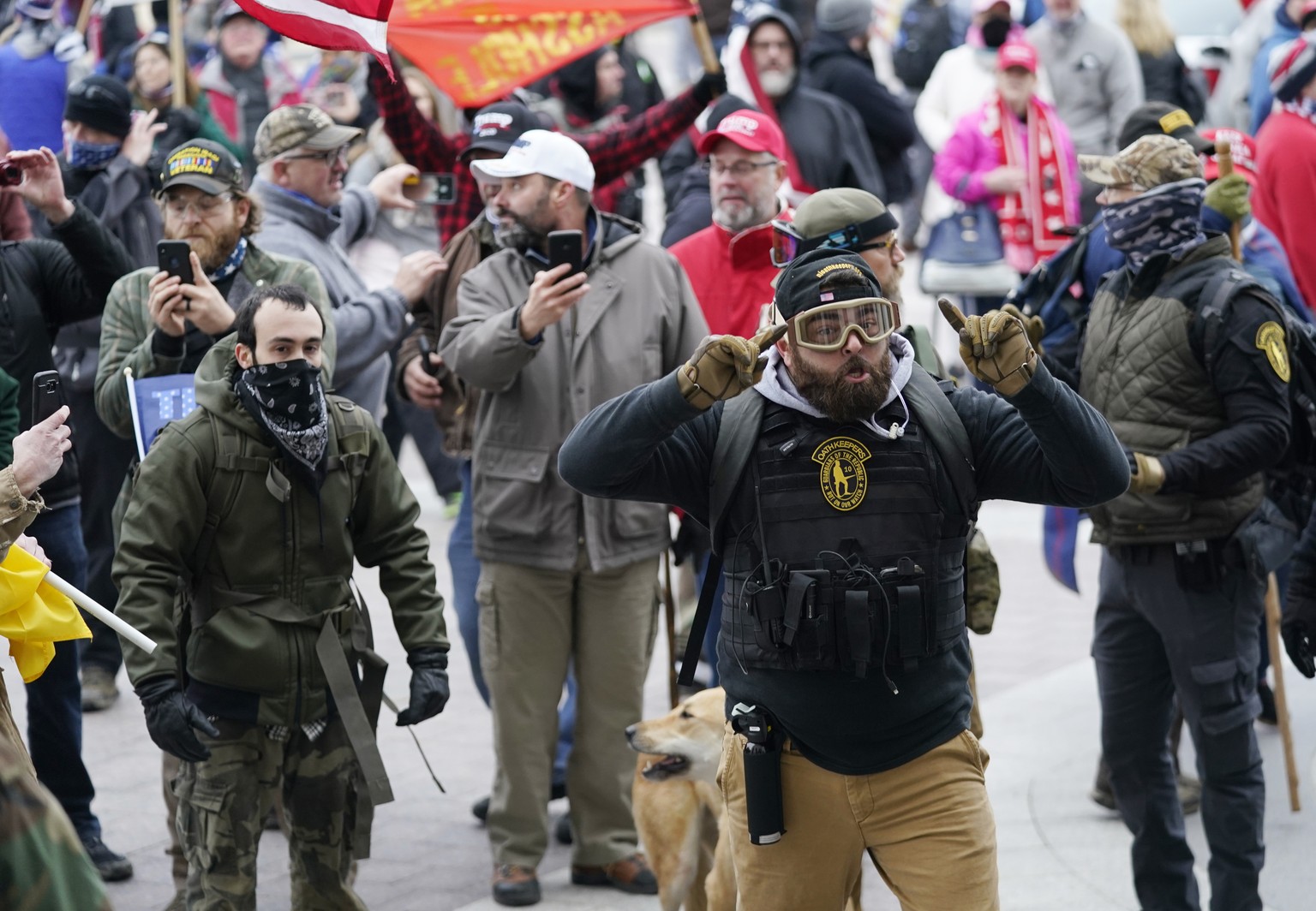 FILE - Trump supporters use their cell phones to record events as they gather outside the Capitol, Jan. 6, 2021, in Washington as Congress prepares to affirm President-elect Joe Biden&#039;s victory.  ...