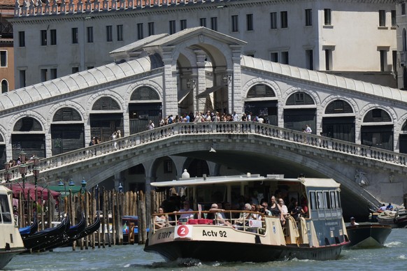 The Rialto Bridge is crowded with tourists, in Venice, Italy, Friday, June 27, 2025. (AP Photo/Luca Bruno)
Italy Overtourism