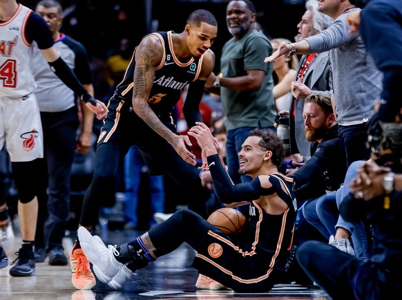 epa10409788 Atlanta Hawks guard Trae Young (R) reacts with Atlanta Hawks guard Dejounte Murray (L) after Young was fouled by the Miami Heat late the second half of the NBA basketball game between the  ...