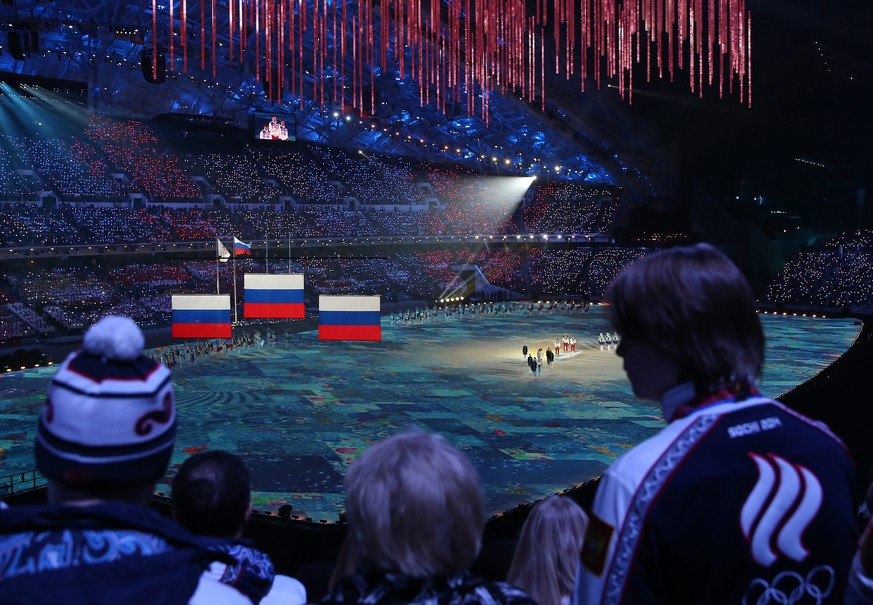 epa04097973 Spectators watch the medal cermony for the Men&#039;s 50km Mass Start Cross Country Skiing race during the Closing Ceremony of the Sochi 2014 Olympic Games at the Fisht Olympic Stadium, So ...