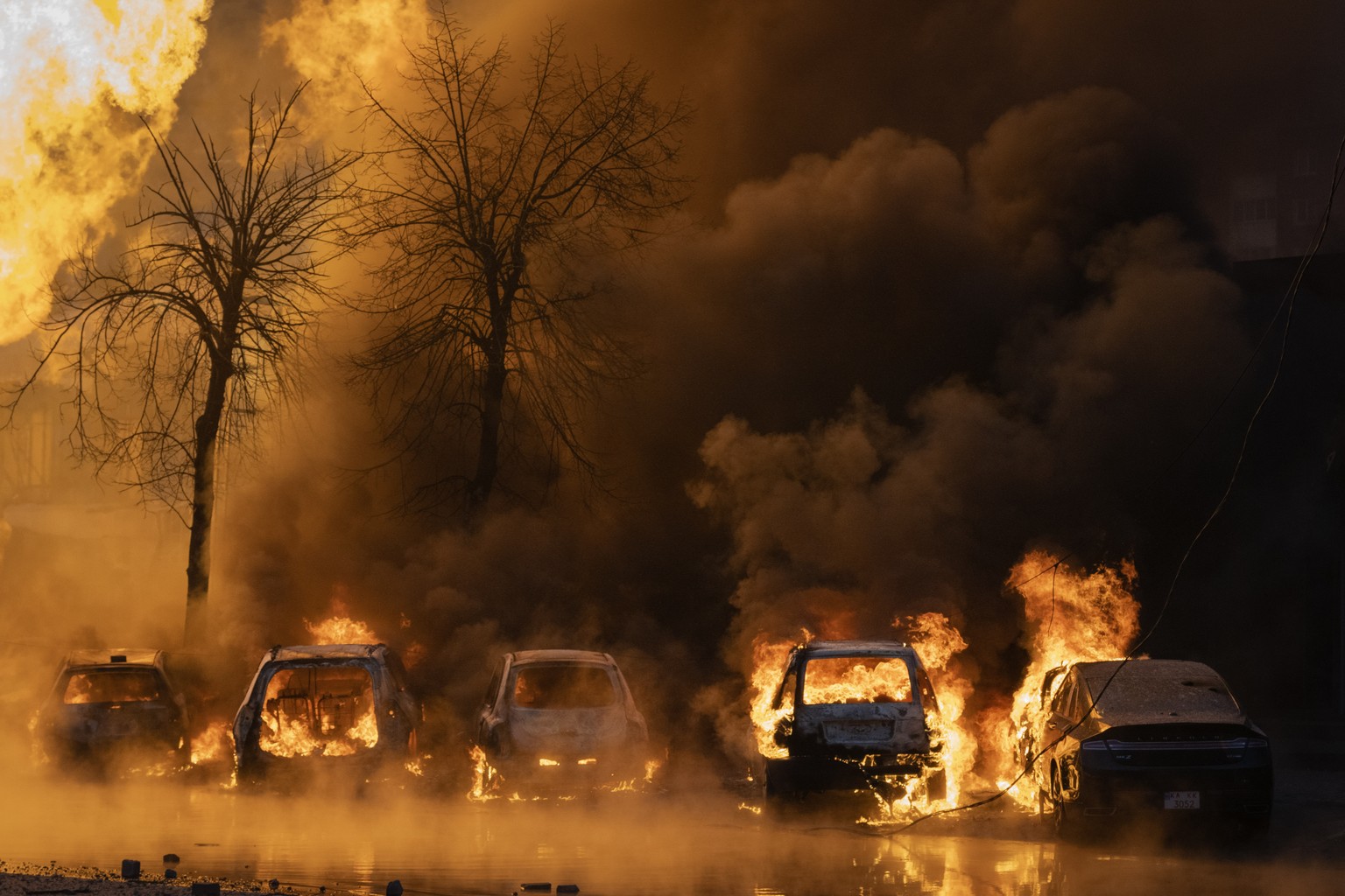Cars burn after a Russian attack in Kyiv, Ukraine, Tuesday, Jan. 2, 2024. (AP Photo/Efrem Lukatsky)