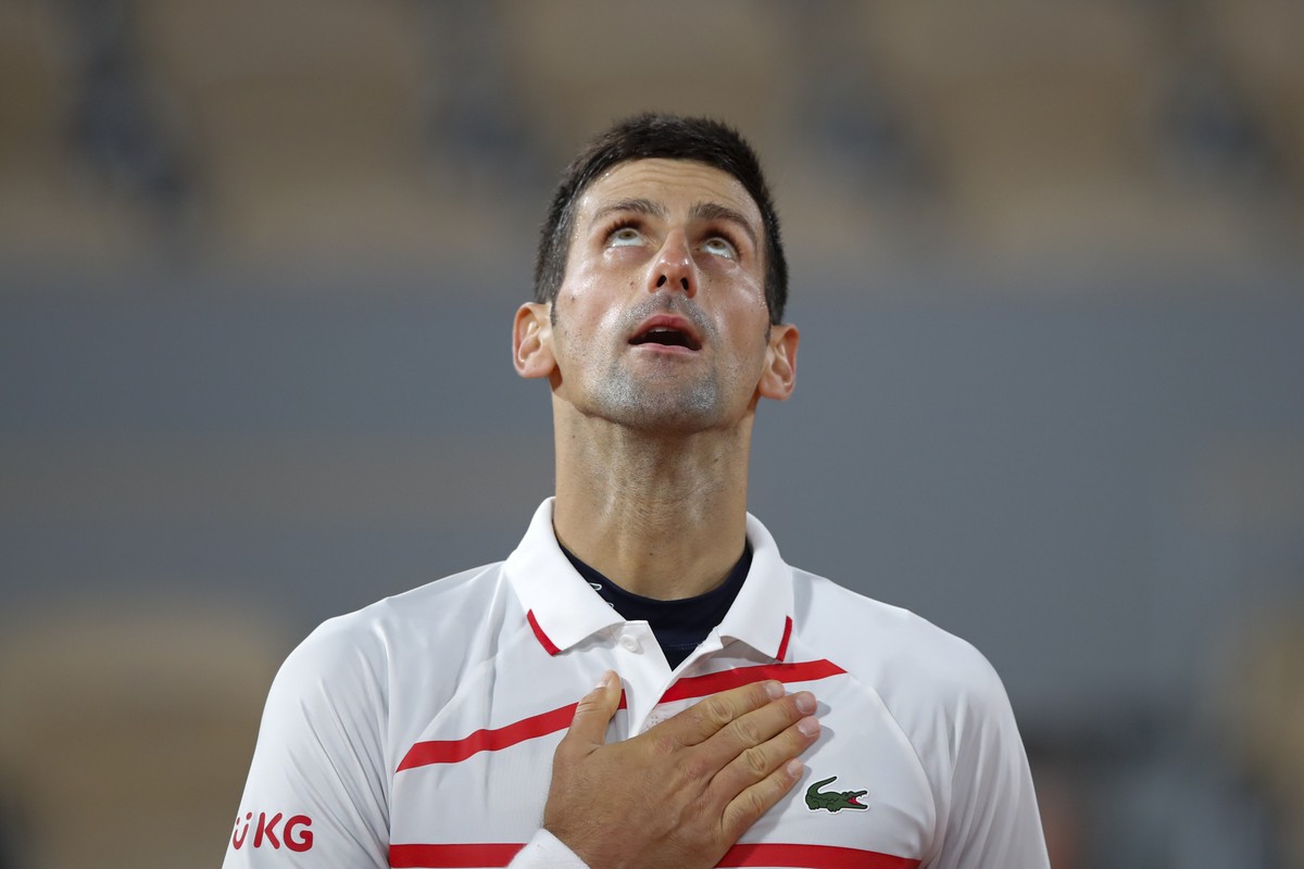 Serbia's Novak Djokovic celebrates winning his the quarterfinal match of the French Open tennis tournament against Spain's Pablo Carreno Busta in four sets, 4-6, 6-2, 6-3, 6-4, at the Roland ...