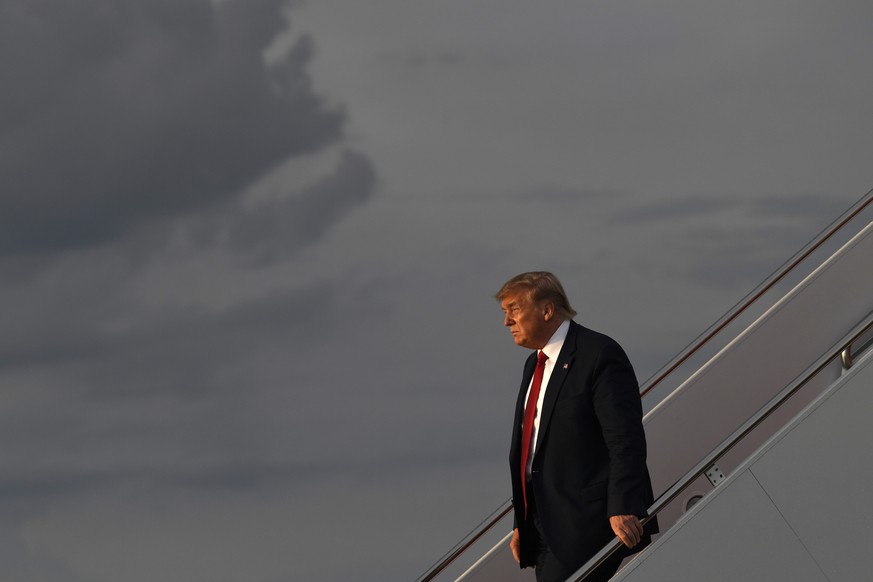 President Donald Trump walks down the steps of Air Force One at Andrews Air Force Base in Md., Wednesday, Aug. 21, 2019. Trump is returning from Louisville, Ky., where he spoke to the American Veteran ...