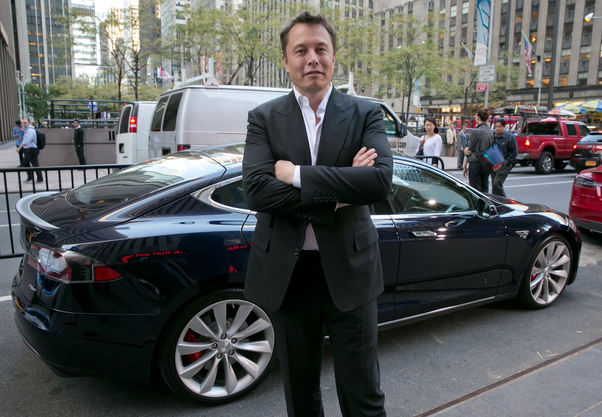 SpaceX billionaire founder and chief executive, and Tesla Motors CEO Elon Musk, poses beside a Tesla, after his interview on "Countdown to the Closing Bell," on the Fox Business Network, in  ...