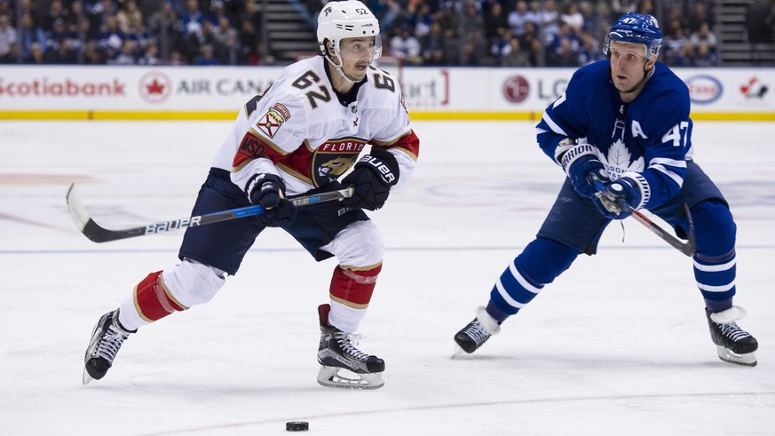 Toronto Maple Leafs center Leo Komarov (47) defends against Florida Panthers center Denis Malgin (62) during the third period of an NHL hockey game Tuesday, Feb. 20, 2018, in Toronto. (Christopher Kat ...