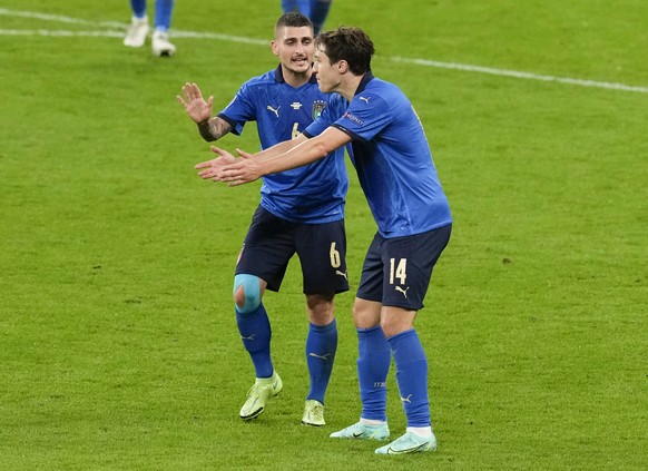 Italy's Federico Chiesa, right, gestures to teammate Marco Verratti during the Euro 2020 soccer championship semifinal between Italy and Spain at Wembley stadium in London, Tuesday, July 6, 2021. ...