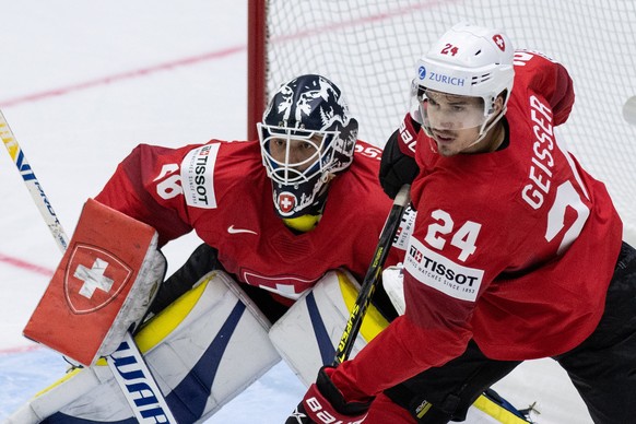 epa09953417 Switzerland&#039;s goaltender Sandro Aeschlimann (L) and Tobias Geisser in action during the Ice Hockey World Championship group A preliminary round match between Switzerland and Kazachsta ...