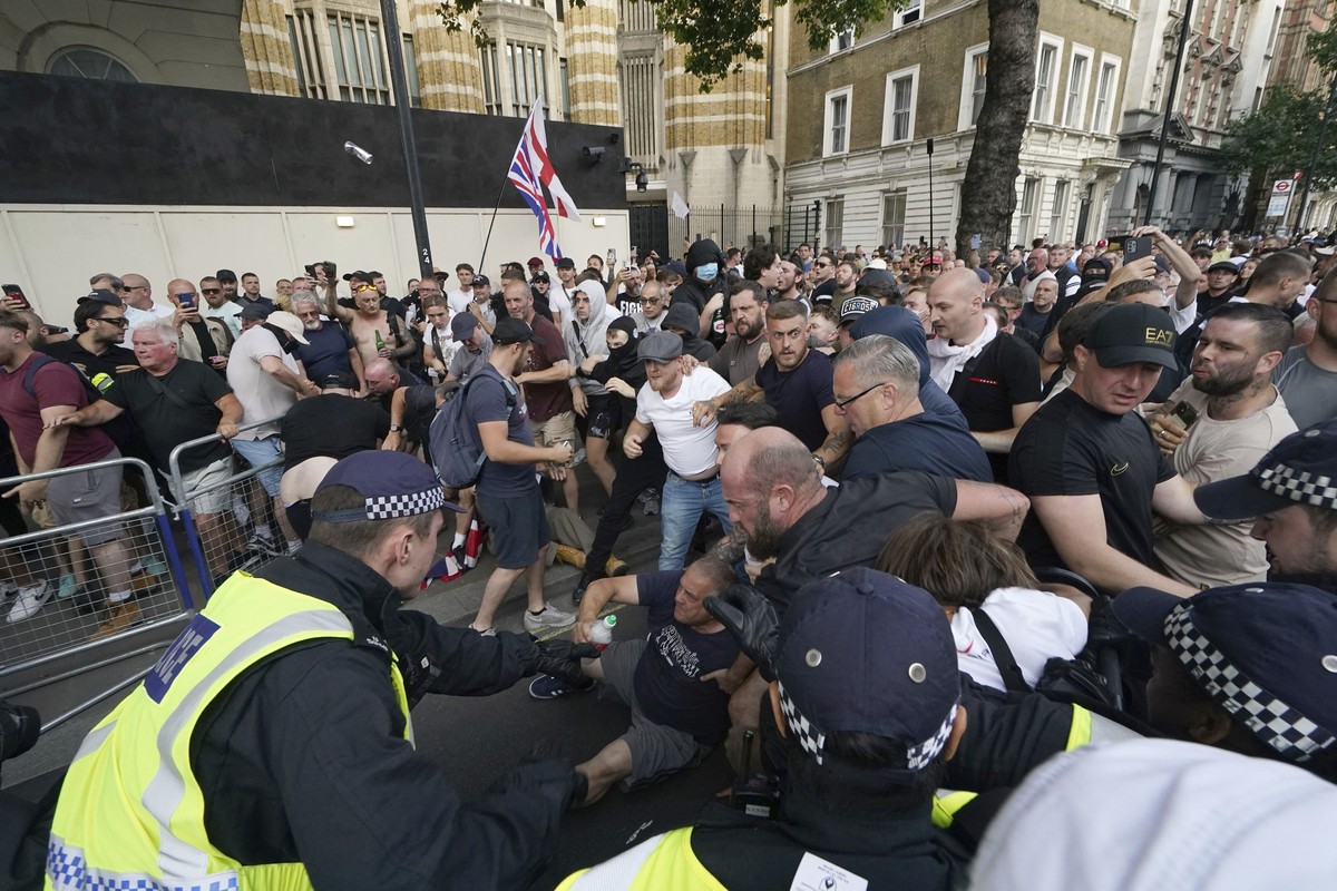 Police officers clash with protesters during a 'Enough is Enough' protest rally in Whitehall, London, Wednesday July 31, 2024 following the fatal stabbing of three children at a Taylor Swift ...