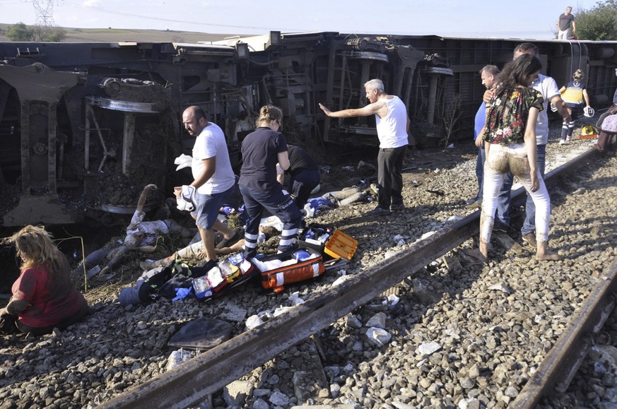 Emergency services rescue victims from overturned train cars near a village in Tekirdag province, Turkey Sunday, July 8, 2018. At least 10 people were killed and more than 70 injured Sunday when multi ...