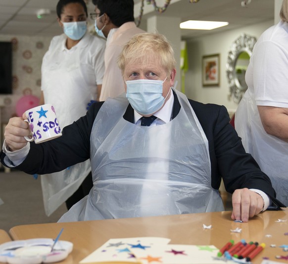 Britain&#039;s Prime Minister Boris Johnson takes part in an activity, during a visit to Westport Care Home in Stepney Green, east London, Tuesday, Sept. 7, 2021, ahead of unveiling his long-awaited p ...