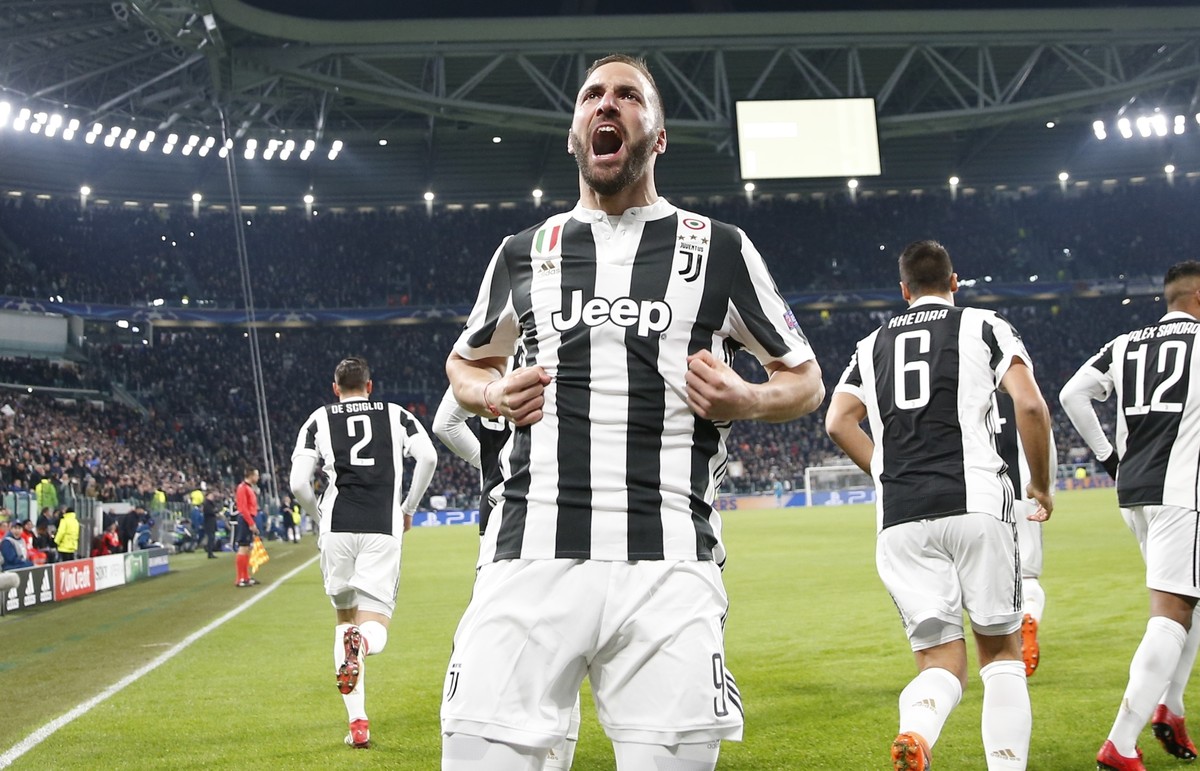 Juventus' Gonzalo Higuain celebrates after scoring his side's opening goal during the Champions League, round of 16, first-leg soccer match between Juventus and Tottenham Hotspurs, at the Al ...