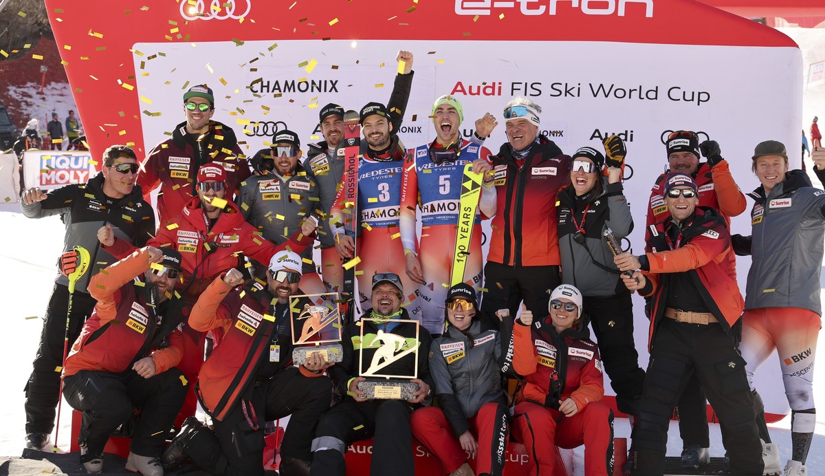 Switzerland's Daniel Yule, center, winner of an an alpine ski, men's World Cup slalom and second-placed Switzerland's Loic Meillard, center left, celebrate with the team, in Chamonix, F ...