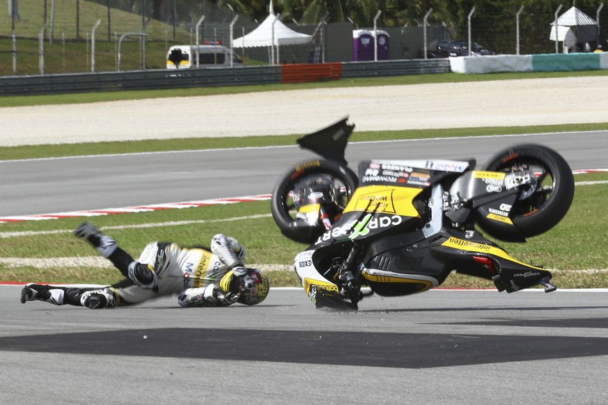 In this Saturday, Oct. 28, 2017, file photo, Switzerland&#039;s Moto2 rider Thomas Luthi crashes during the qualifying session of the Malaysia Moto2 at the Sepang International circuit in Sepang, Mala ...