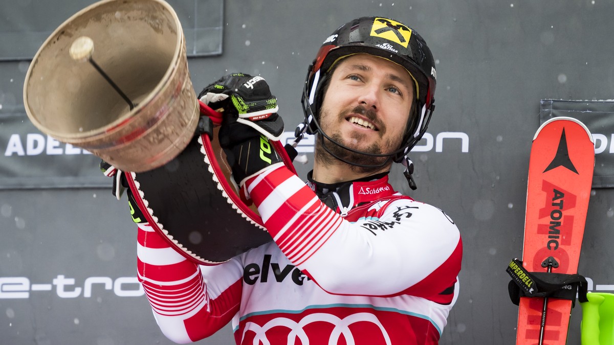 Winner Marcel Hirscher of Austria, celebrates with a Swiss Cow Bell on the podium after the second run of the men's slalom race at the Alpine Skiing FIS Ski World Cup in Adelboden, Switzerland, S ...